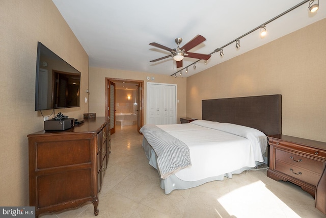 bedroom featuring a closet, rail lighting, and ceiling fan