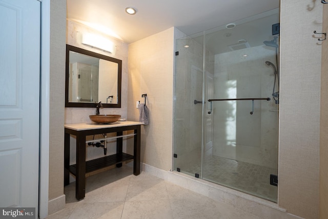 bathroom with vanity, tile patterned flooring, baseboards, and a stall shower