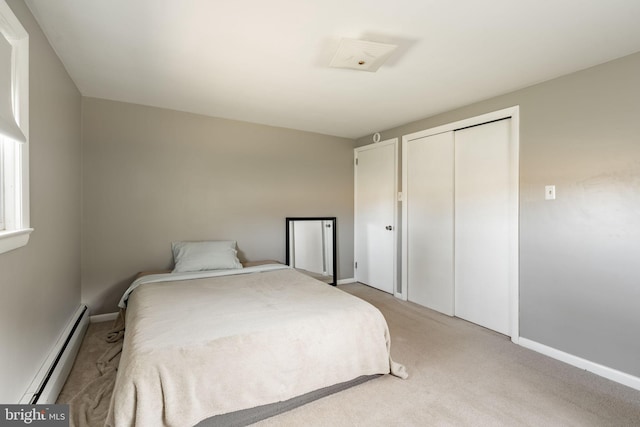 bedroom with light colored carpet, baseboards, a baseboard heating unit, and a closet