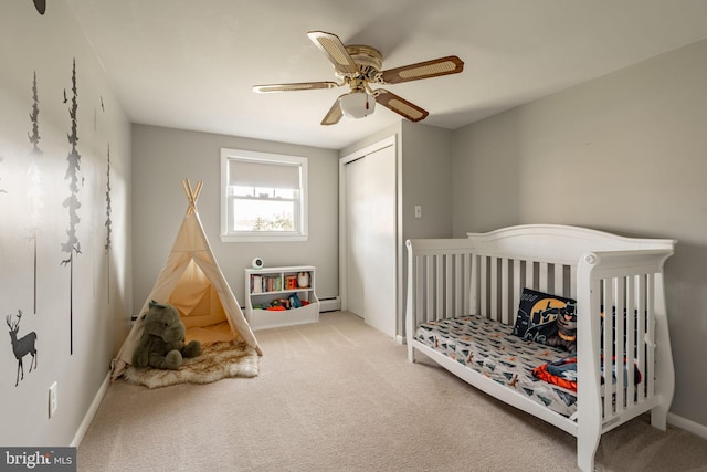bedroom featuring ceiling fan, carpet floors, baseboards, a closet, and a baseboard heating unit