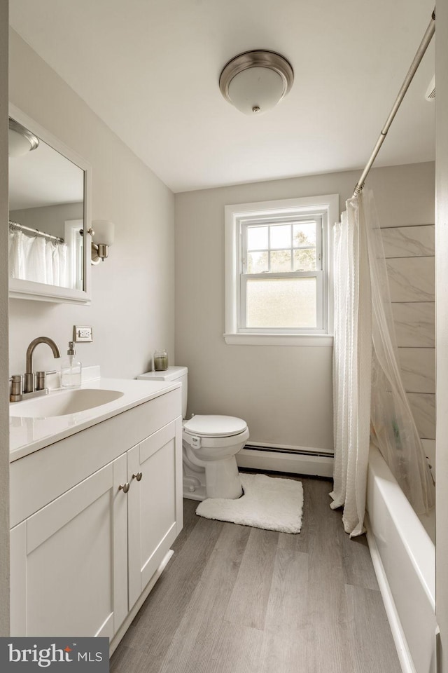 bathroom featuring vanity, shower / bath combo with shower curtain, wood finished floors, toilet, and baseboard heating