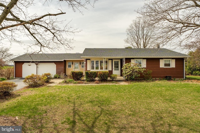 ranch-style house with a garage, driveway, and a front lawn