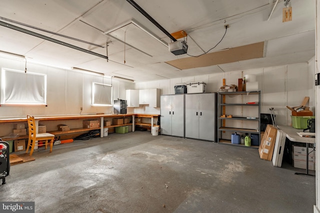 garage featuring a workshop area and a garage door opener