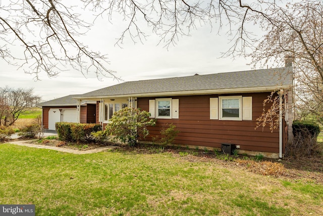 ranch-style home with a garage and a front yard