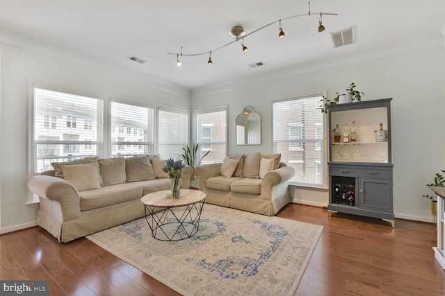 living room featuring crown molding, visible vents, and dark wood finished floors
