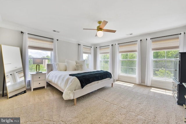 bedroom with crown molding, carpet, and visible vents