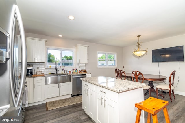 228 Purdue Ave, Pemberton, NJ 08068 - kitchen featuring stainless steel appliances, a sink, a center island, dark wood finished floors, and decorative backsplash