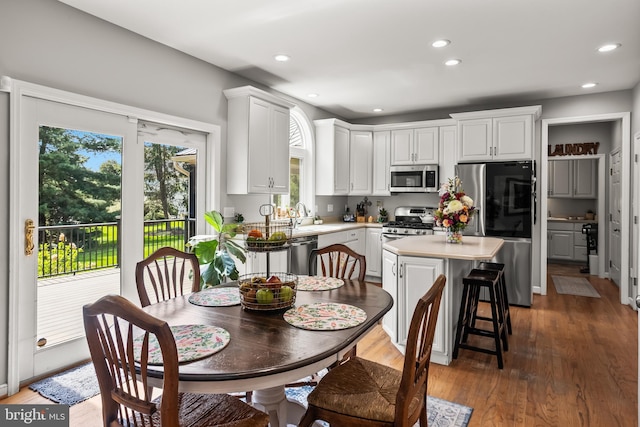 kitchen with white cabinetry, a center island, appliances with stainless steel finishes, and light countertops