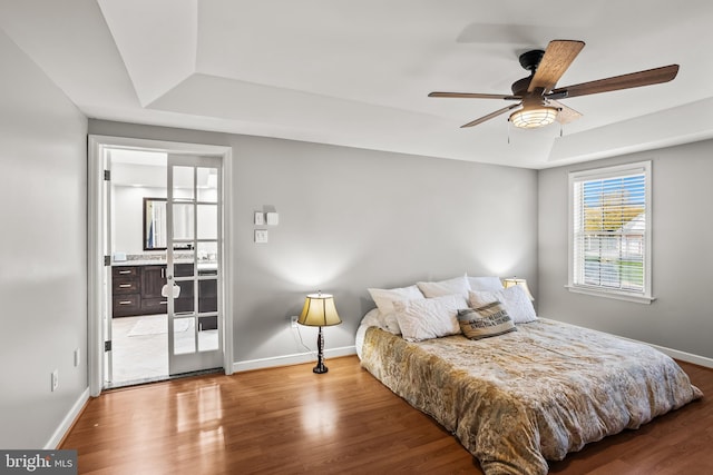 bedroom featuring baseboards and a raised ceiling