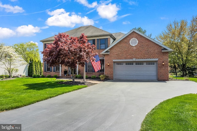 traditional-style house featuring concrete driveway, a garage, a front lawn, and brick siding