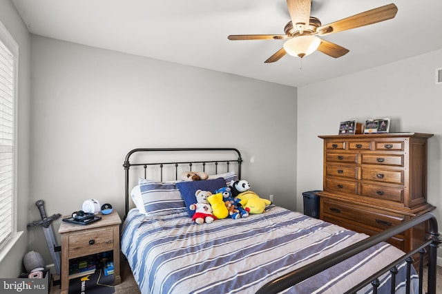 carpeted bedroom with visible vents and ceiling fan