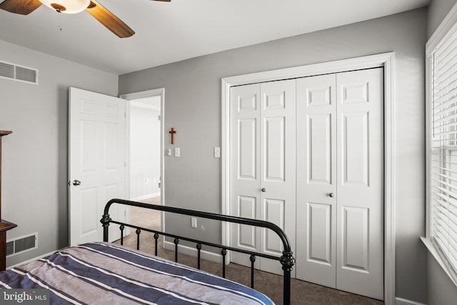 bedroom featuring a closet, visible vents, ceiling fan, and carpet floors