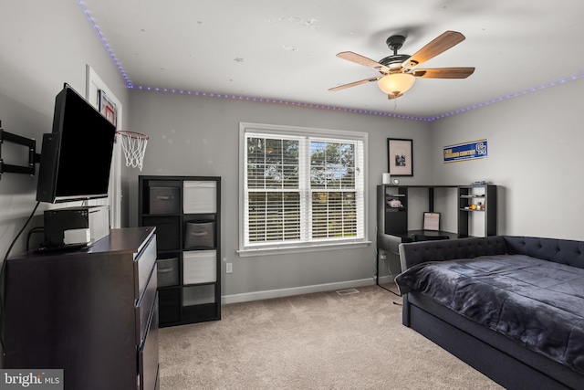 bedroom featuring light colored carpet, visible vents, a ceiling fan, and baseboards