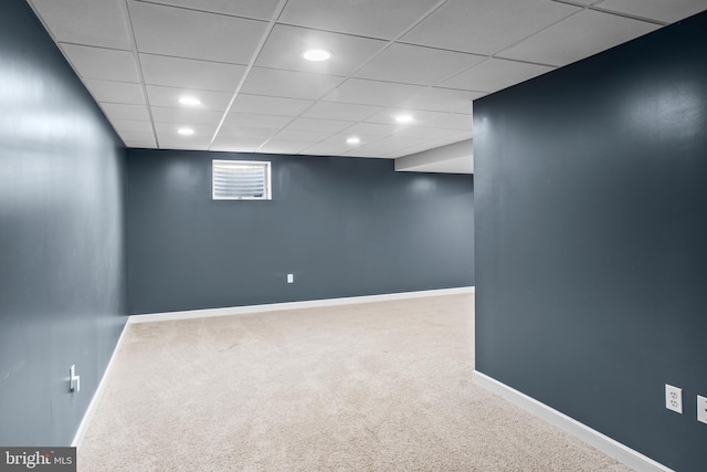below grade area featuring recessed lighting, a drop ceiling, carpet, and baseboards