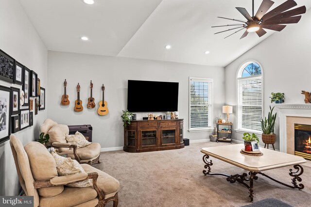 living room with recessed lighting, ceiling fan, a glass covered fireplace, carpet, and baseboards