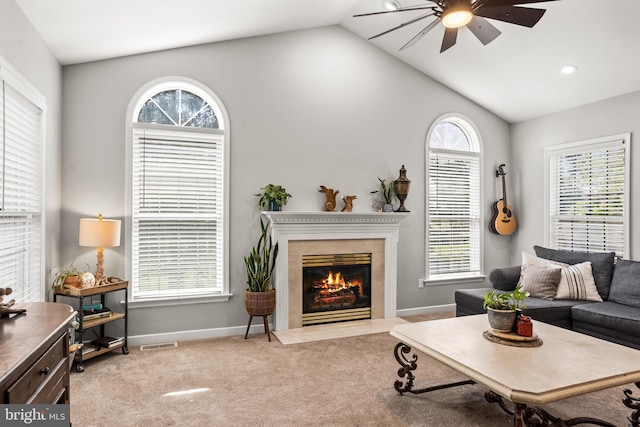 living room with ceiling fan, visible vents, vaulted ceiling, and baseboards
