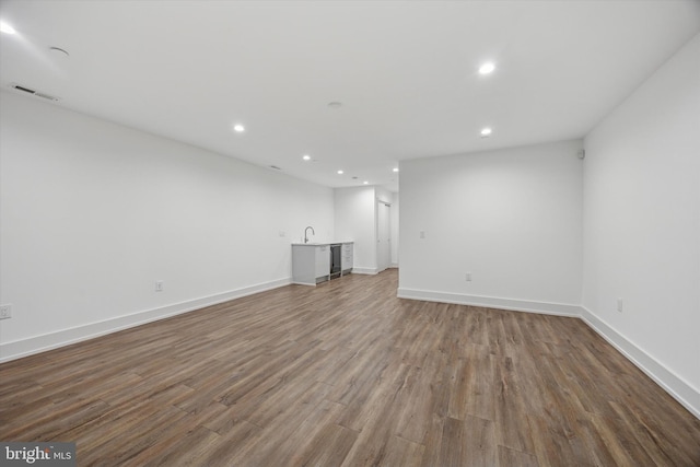 602 N 5th St Unit 5, Philadelphia, PA 19123 - unfurnished living room with wood finished floors, bar, baseboards, visible vents, and recessed lighting