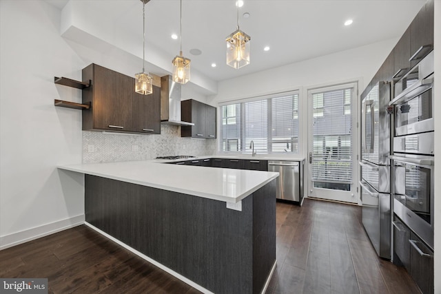 602 N 5th St Unit 5, Philadelphia, PA 19123 - kitchen featuring stainless steel appliances, open shelves, light countertops, wall chimney range hood, and a peninsula