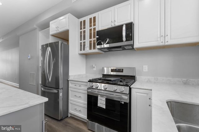 3420 E Baltimore St, Baltimore, MD 21224 - kitchen with stainless steel appliances, light stone countertops, white cabinets, and glass insert cabinets