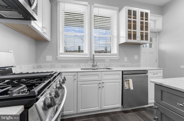 3420 E Baltimore St, Baltimore, MD 21224 - kitchen featuring dark wood-style flooring, a sink, glass insert cabinets, white cabinetry, and appliances with stainless steel finishes
