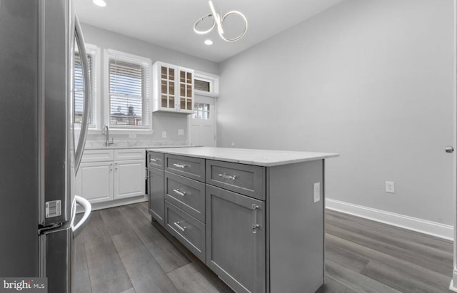 3420 E Baltimore St, Baltimore, MD 21224 - kitchen with gray cabinetry, a kitchen island, freestanding refrigerator, and dark wood finished floors