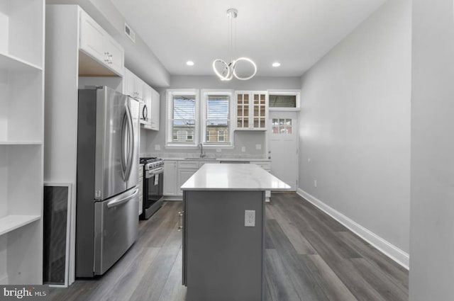 3420 E Baltimore St, Baltimore, MD 21224 - kitchen featuring white cabinetry, a kitchen island, appliances with stainless steel finishes, and dark wood-type flooring