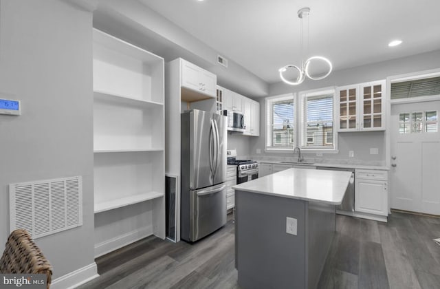 3420 E Baltimore St, Baltimore, MD 21224 - kitchen with white cabinetry, open shelves, a sink, stainless steel appliances, and dark wood-style floors