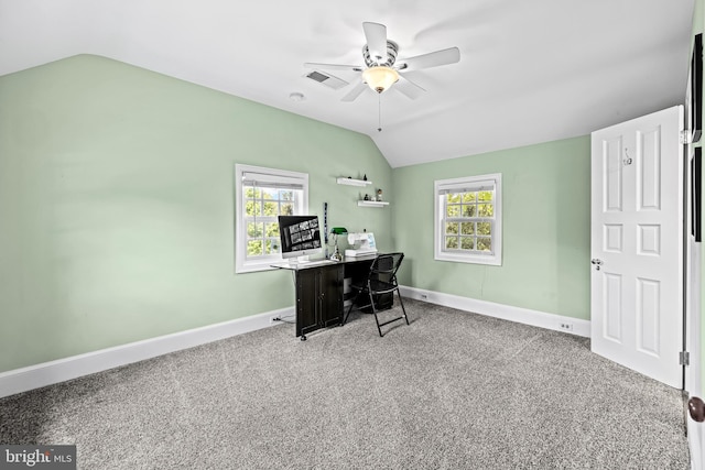 carpeted office space with vaulted ceiling, ceiling fan, healthy amount of natural light, and baseboards