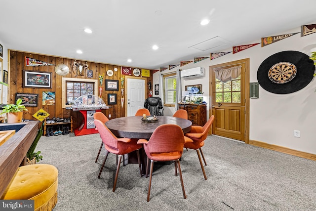 dining space featuring carpet floors, recessed lighting, an AC wall unit, wooden walls, and baseboards
