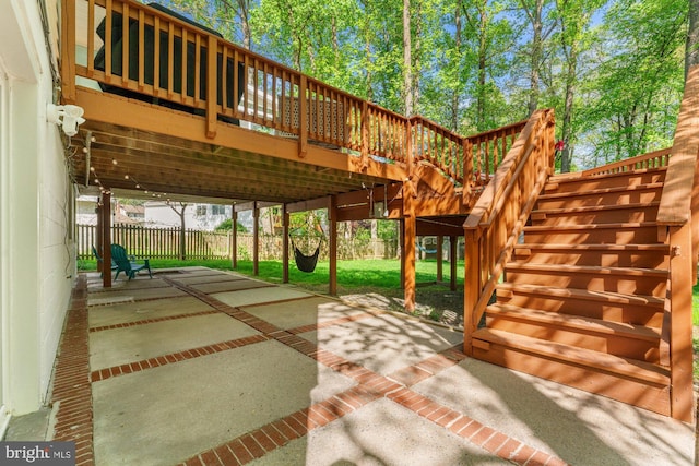 view of patio featuring stairway, a fenced backyard, and a wooden deck