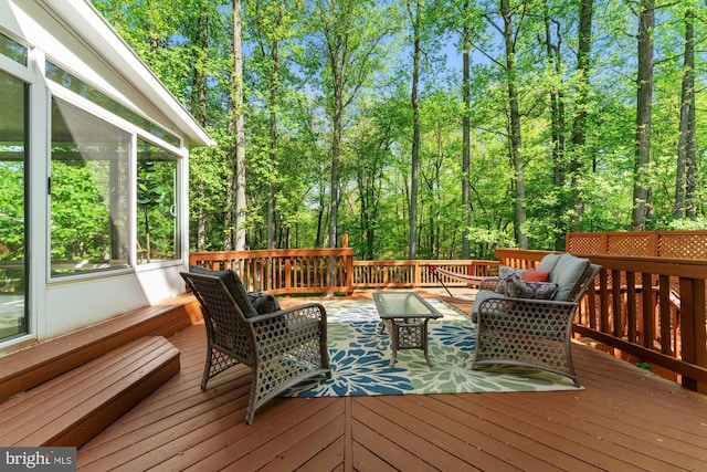 deck featuring a sunroom and an outdoor living space
