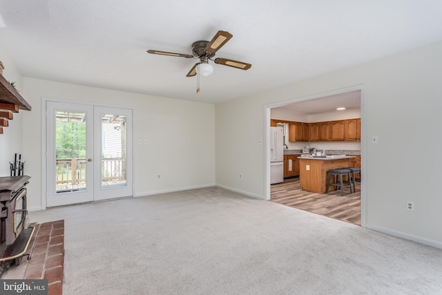 275 Wood Rise Ln, Winchester, VA 22602 - unfurnished living room with light colored carpet, a ceiling fan, baseboards, and a wood stove