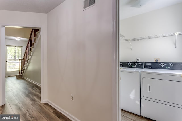 275 Wood Rise Ln, Winchester, VA 22602 - clothes washing area featuring baseboards, visible vents, light wood finished floors, and washer and dryer