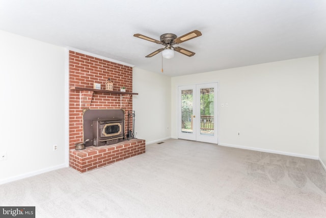 275 Wood Rise Ln, Winchester, VA 22602 - unfurnished living room with baseboards, ceiling fan, a wood stove, and carpet flooring