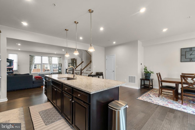 kitchen with a sink, dark wood-style flooring, open floor plan, and visible vents
