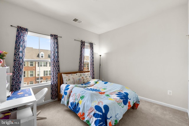 carpeted bedroom featuring visible vents and baseboards