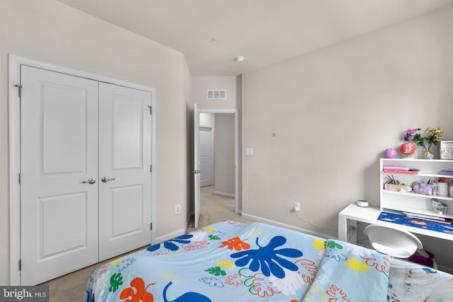 bedroom featuring visible vents, baseboards, a closet, and light colored carpet