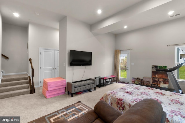 carpeted bedroom featuring multiple windows, recessed lighting, and visible vents