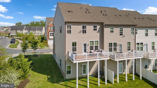 back of house with a residential view, a wooden deck, central AC, a yard, and a shingled roof