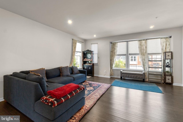living room featuring baseboards, dark wood-style flooring, and recessed lighting