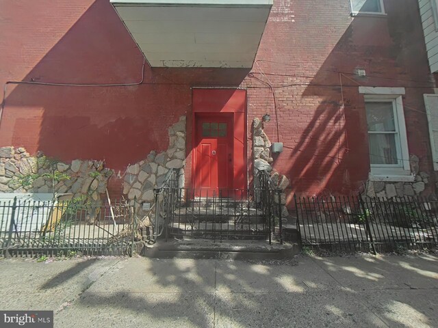 2113 N 17th St, Philadelphia, PA 19121 - entrance to property featuring fence, brick siding, and stone siding