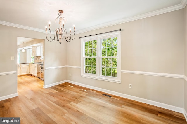 21130 Haystack Ct, Ashburn, VA 20147 - empty room featuring a chandelier, baseboards, ornamental molding, healthy amount of natural light, and light wood-style floors