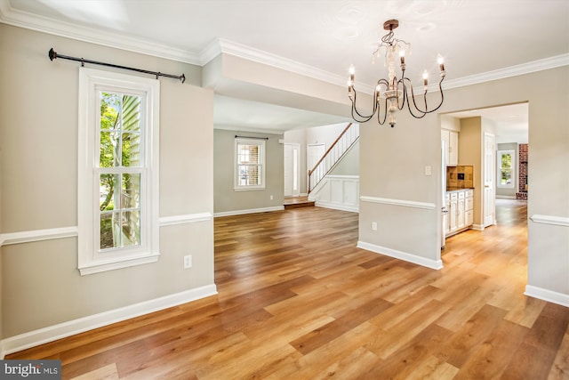 21130 Haystack Ct, Ashburn, VA 20147 - unfurnished dining area with a chandelier, plenty of natural light, light wood-style flooring, and ornamental molding