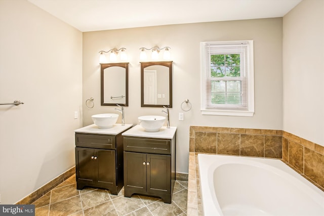 21130 Haystack Ct, Ashburn, VA 20147 - bathroom with double vanity, a garden tub, and baseboards