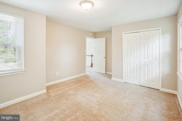 21130 Haystack Ct, Ashburn, VA 20147 - unfurnished bedroom featuring carpet, multiple windows, a closet, and baseboards
