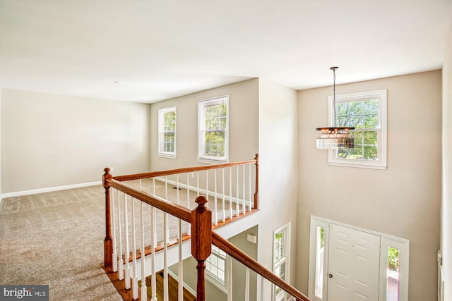 21130 Haystack Ct, Ashburn, VA 20147 - hallway with a chandelier, an upstairs landing, healthy amount of natural light, and baseboards