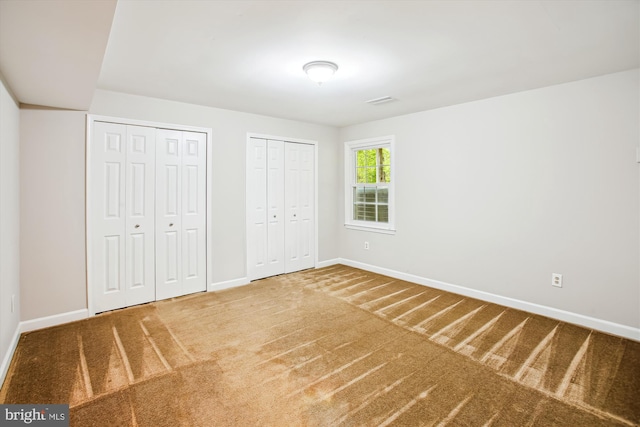21130 Haystack Ct, Ashburn, VA 20147 - unfurnished bedroom featuring multiple closets, baseboards, and carpet