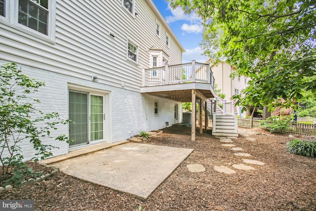 21130 Haystack Ct, Ashburn, VA 20147 - back of house featuring a wooden deck, stairway, a patio area, and brick siding