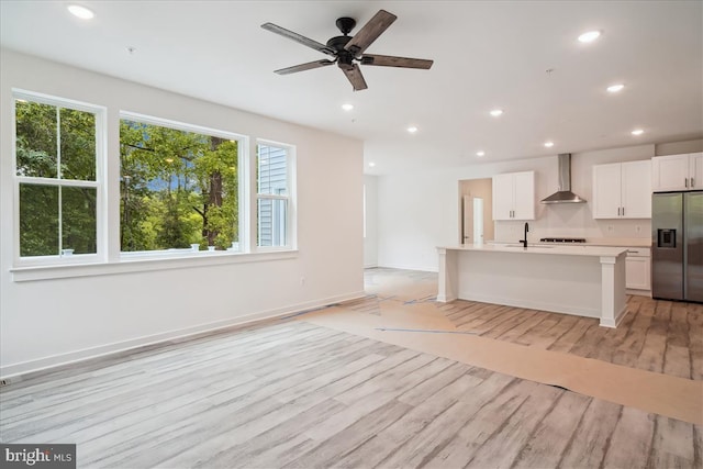 9842 Fire Tower Rd, Ijamsville, MD 21754 - kitchen with wall chimney range hood, stainless steel fridge with ice dispenser, light countertops, light wood-type flooring, and open floor plan