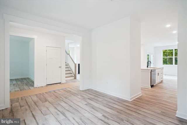 9842 Fire Tower Rd, Ijamsville, MD 21754 - spare room with light wood finished floors, a sink, stairway, baseboards, and recessed lighting